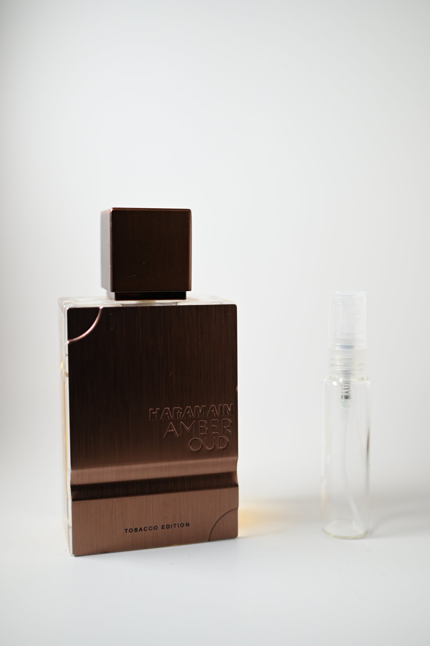 Amber Oud Tobacco Bottle Next to 10ML Decant - Perfumes de Adrian