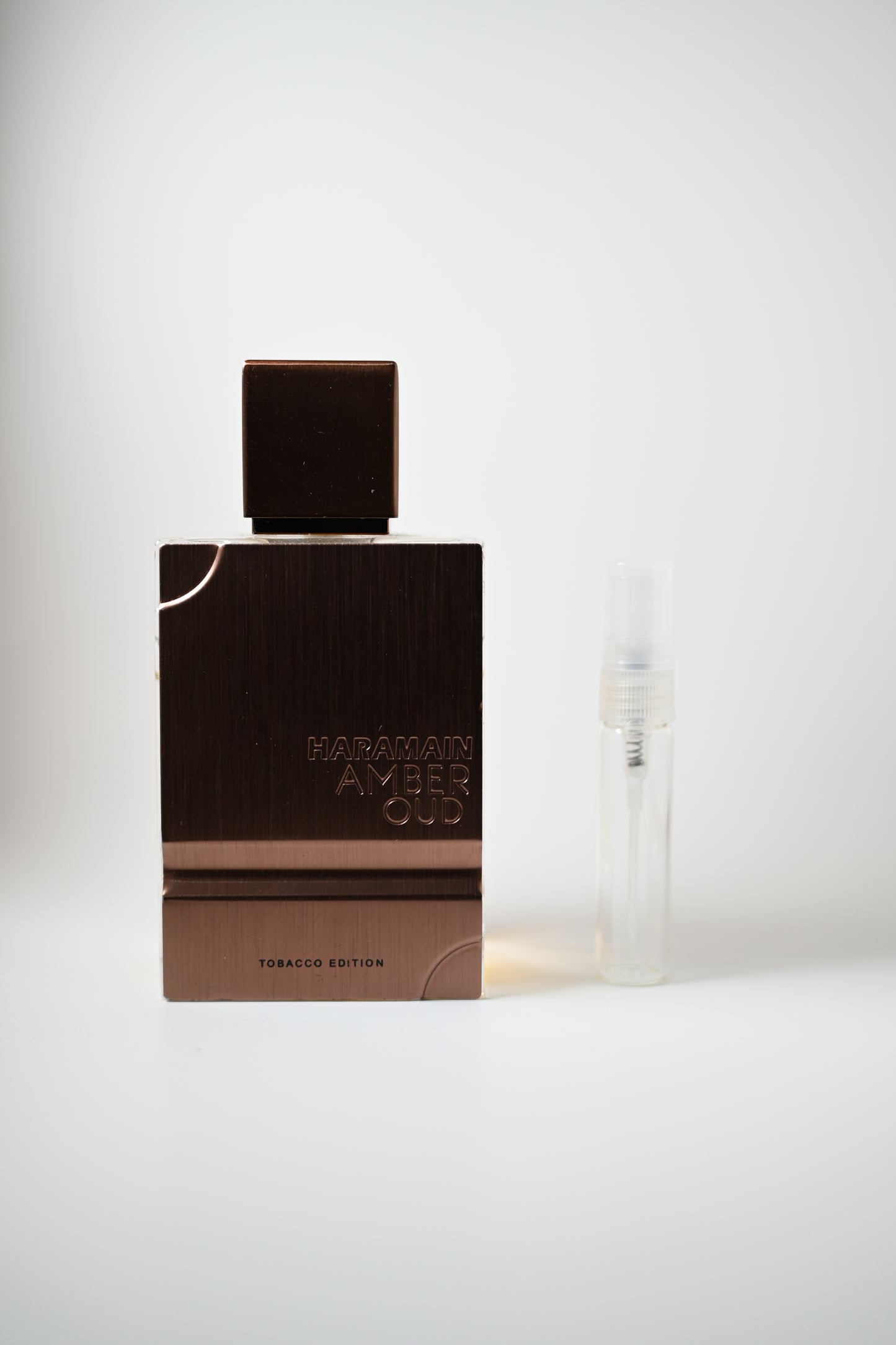 Amber Oud Tobacco Bottle Next to 5ML Decant - Perfumes de Adrian