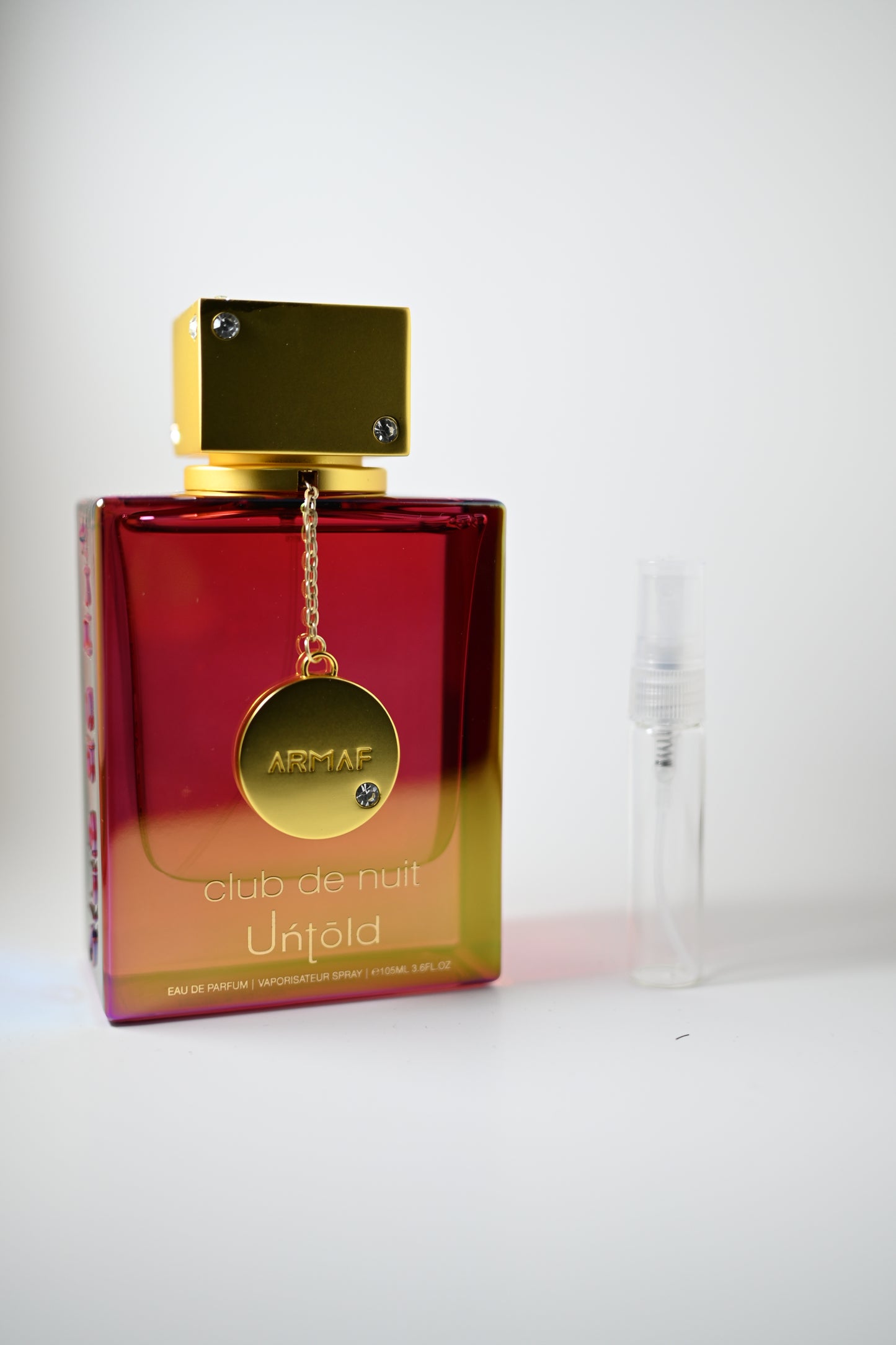 Club de Nuit Untold Bottle Next to 5ML Decant - Perfumes de Adrian